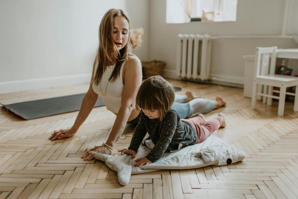 woman showing her child how to stretch, ready for a workout