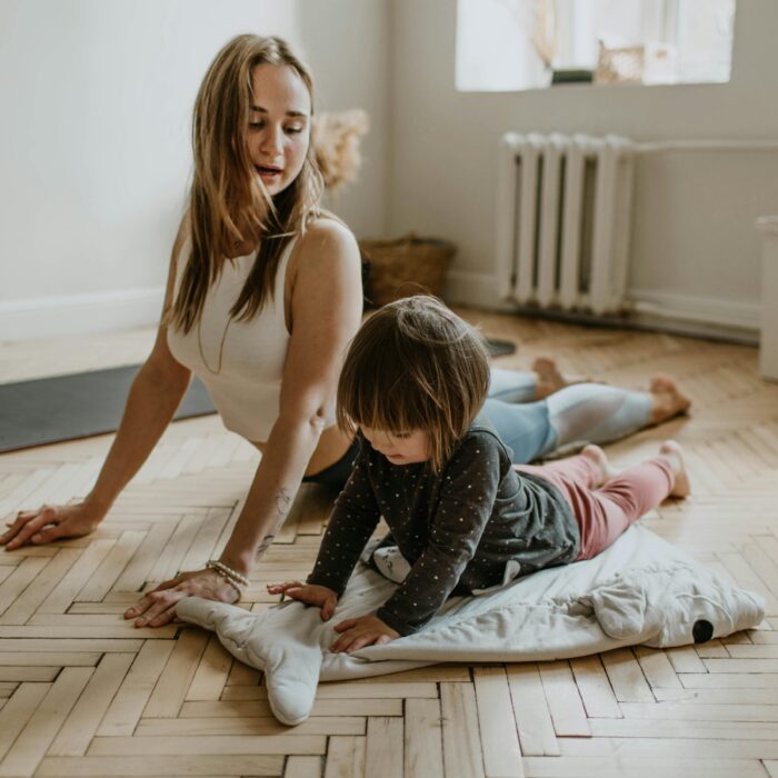 woman showing her child how to stretch, ready for a workout