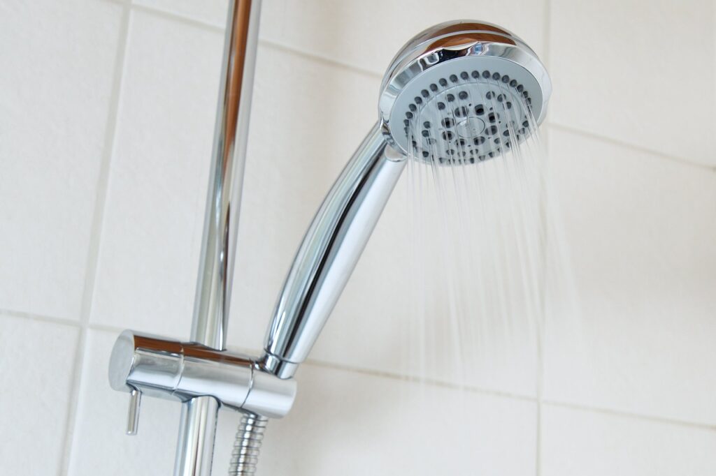 Upward shot of a shower head with water flowing down