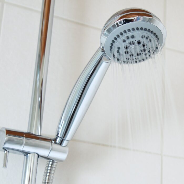 Upward shot of a shower head with water flowing down