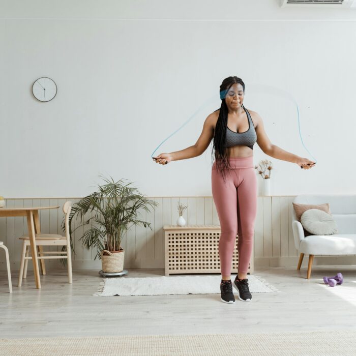 Jump roping in a spacious home, this fitness enthusiast showcases her gym gear and determination