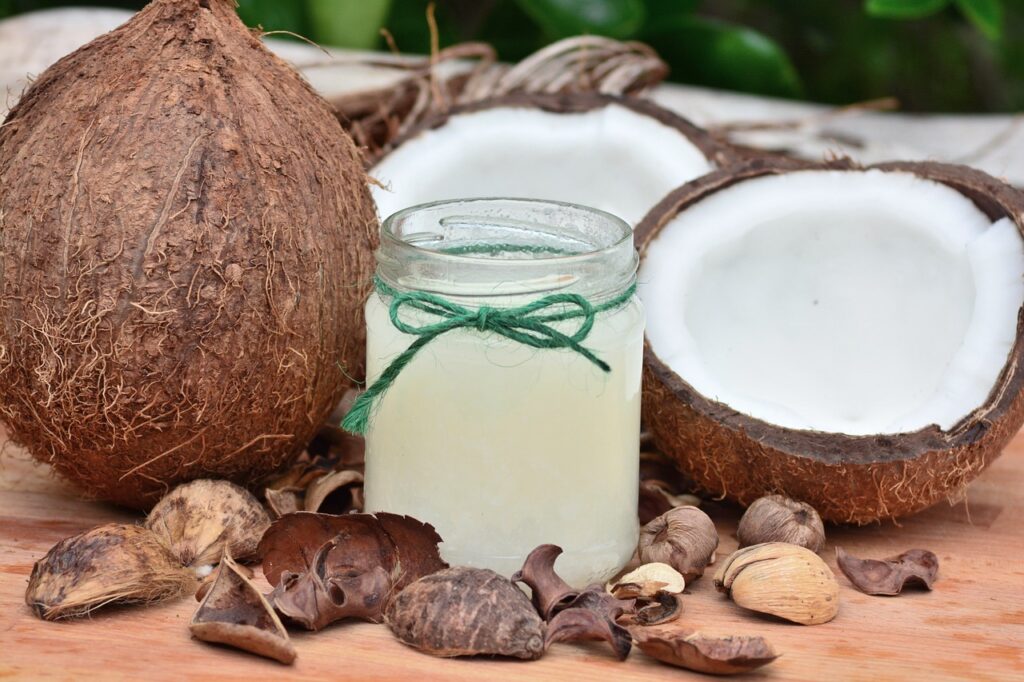 Jar of refreshing coconut water surrounded by open coconuts, highlighting natural hydration