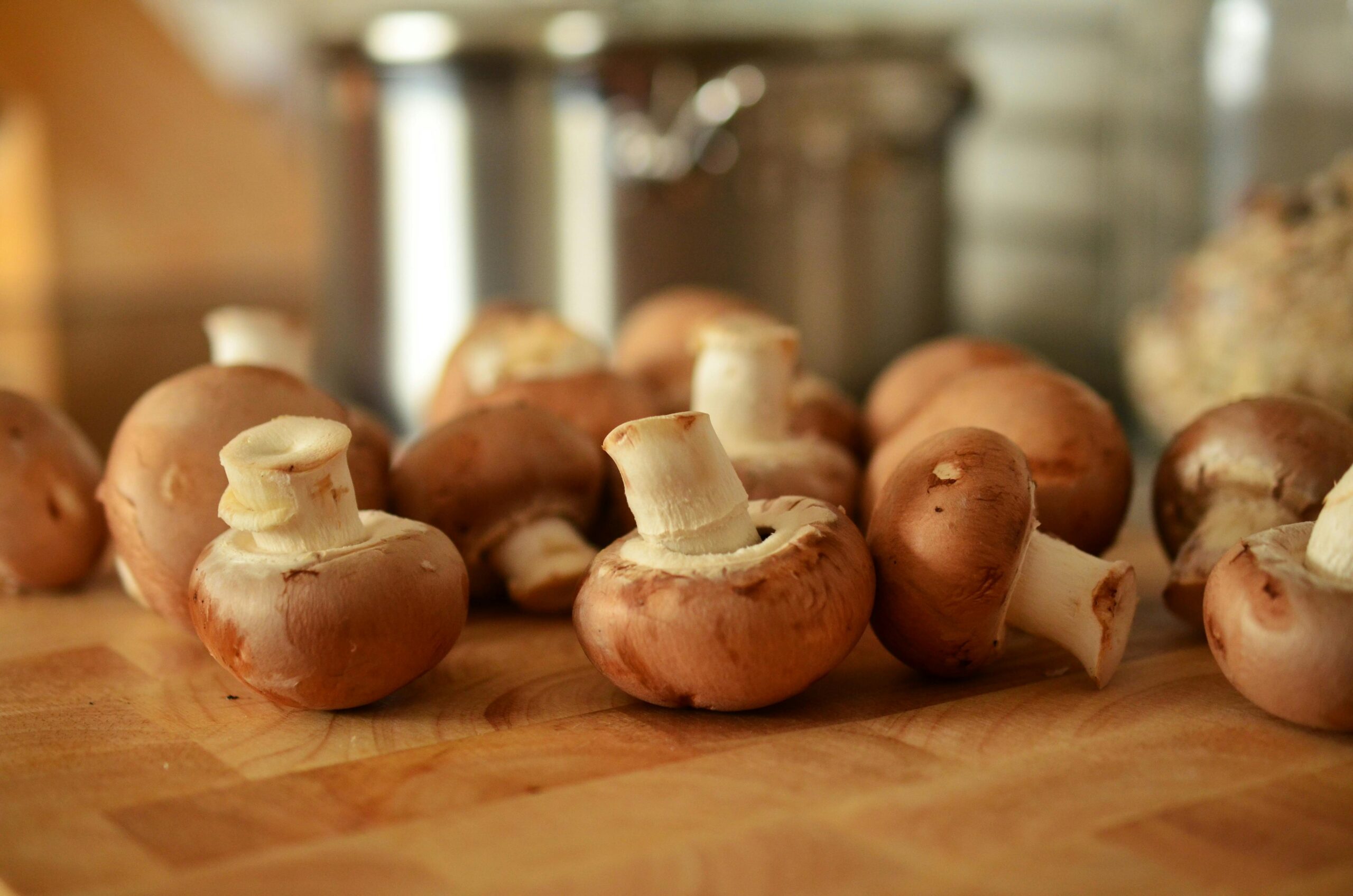 Fresh mushrooms placed on a wooden table.