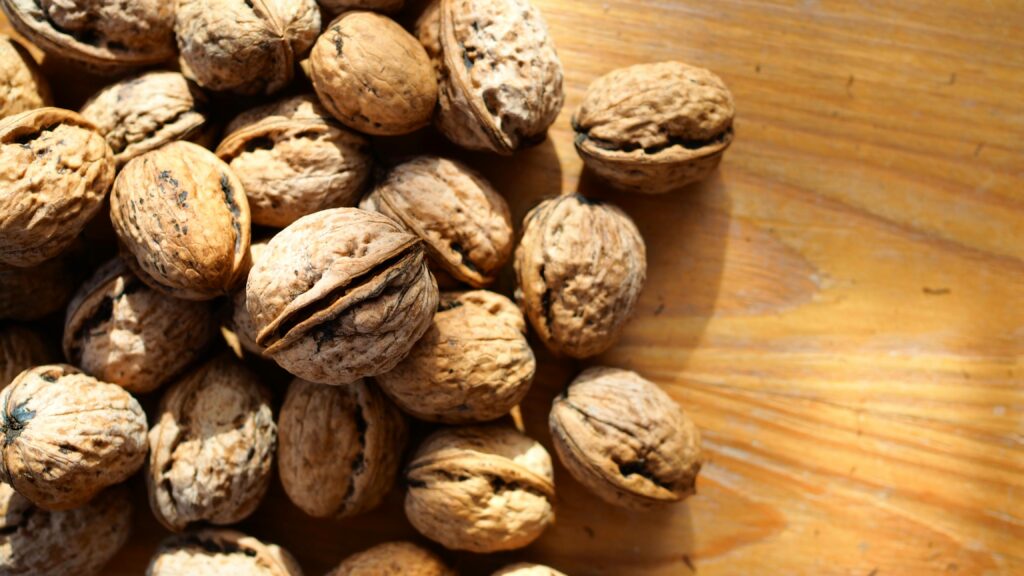 A pile of Brazil nuts on a wooden surface