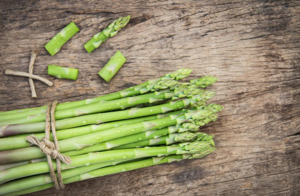 A bunch of Asparagus tied together on a table